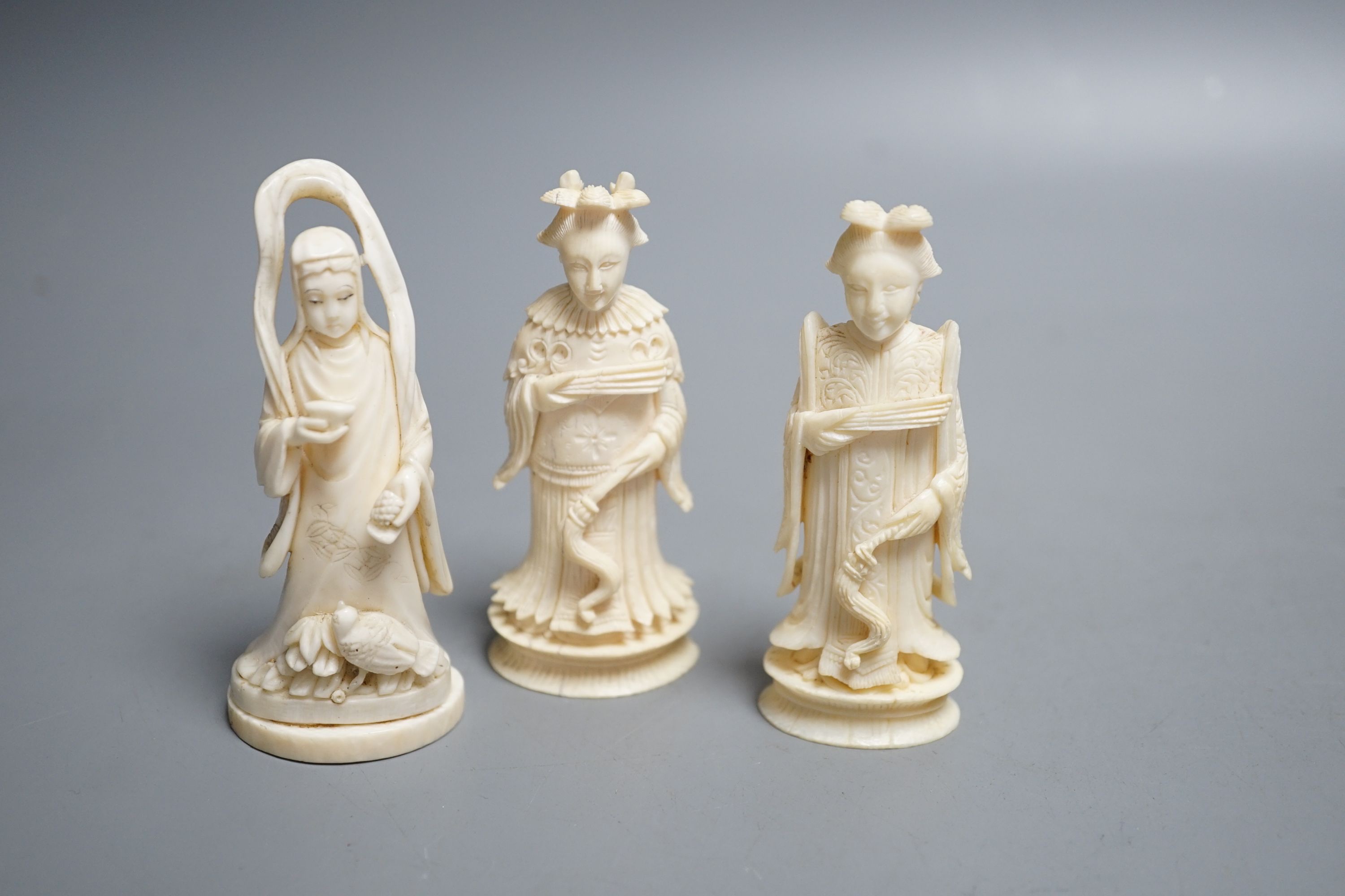 A Chinese ivory figure of Guanyin, a pair of ivory chess pieces, two Cantonese napkin rings and a Cantonese ivory plaque with flowers, 19th/early 20th century , tallest chess piece 8.5 cms high.
